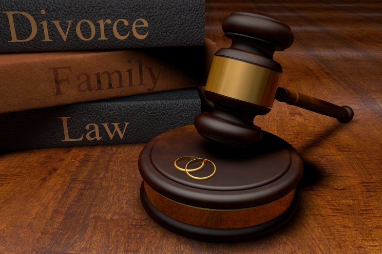 divorce family law books with gavel and wedding rings